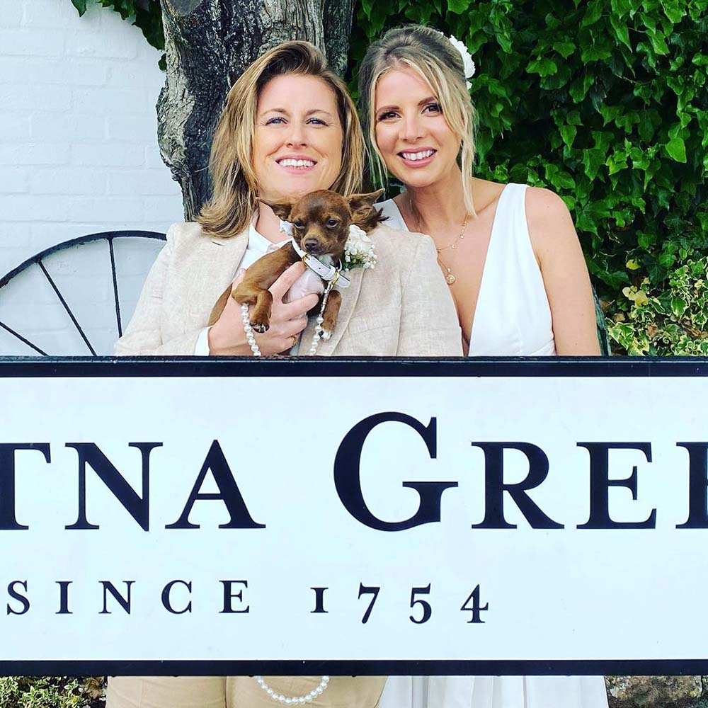 Same sex couple over Gretna Green sign 