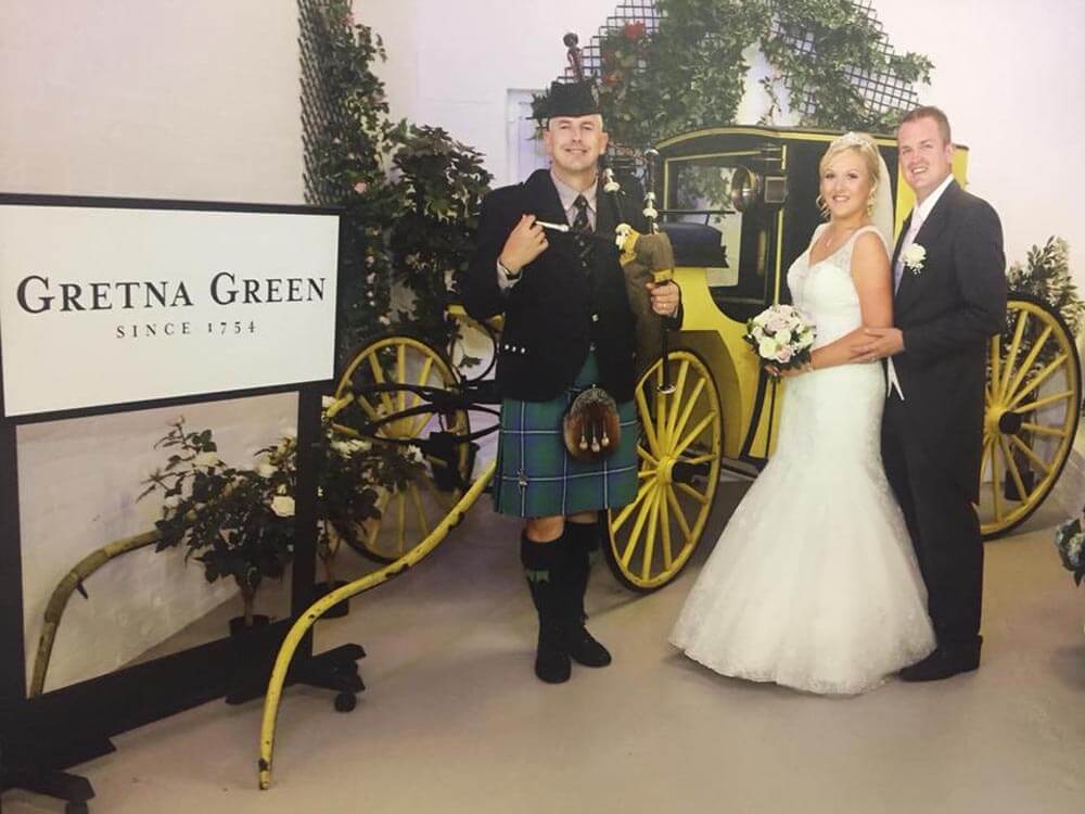 Wedding photo in the Coach Museum at The Gretna Green Famous Blacksmiths Shop