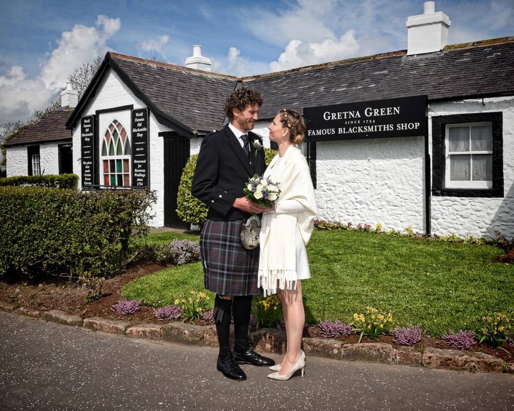 Wedding photo outside the Famous Blacksmiths Shop, Gretna Green Since 1754