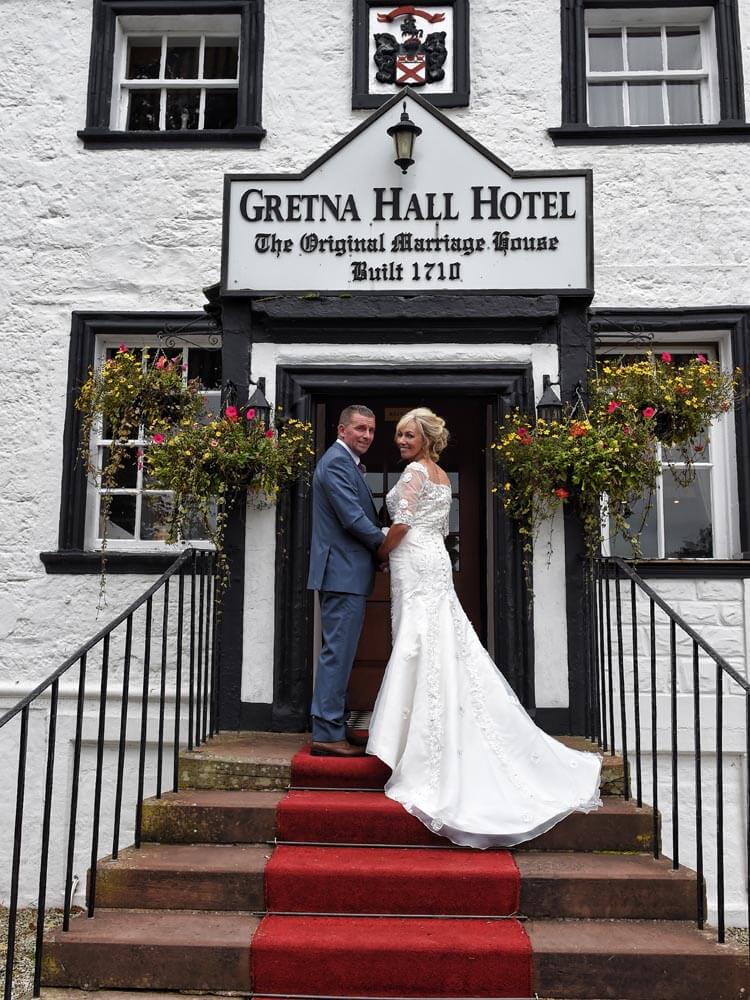 Wedding photo on the front steps of Gretna Hall hotel, Gretna Green