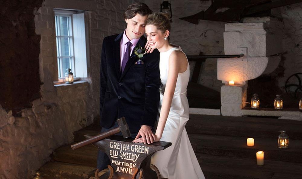 Wedding photo in the Original Marriage Room of the Famous Blacksmiths Shop Gretna Green with the Anvil
